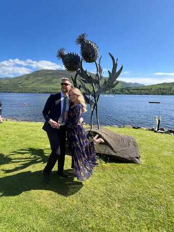 Romantic couple beside the giant thistle sculpture in the garden on Loch Earn at Briar Cottages Lochearnhead