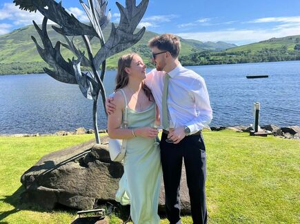 PicRomantic coupe with champagne in front of a giant steel thistle sculpture by Loch Earn